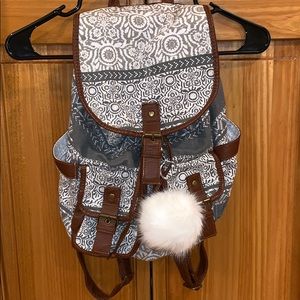 Claire’s backpack with white puff ball